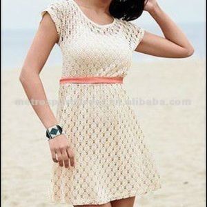 Tan crochet, knit dress with coral ribbon.